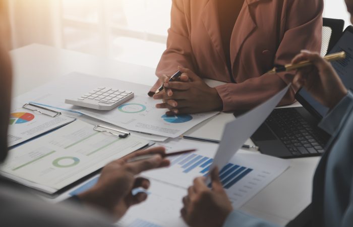 Close up of Business team analyzing income charts and graphs wit